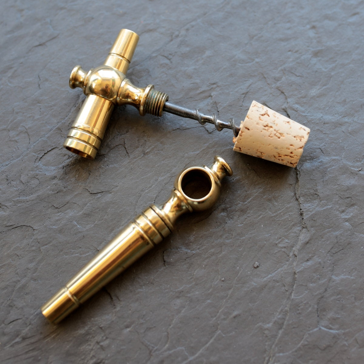 Patinated brass bottle opener cork in the shape of a key